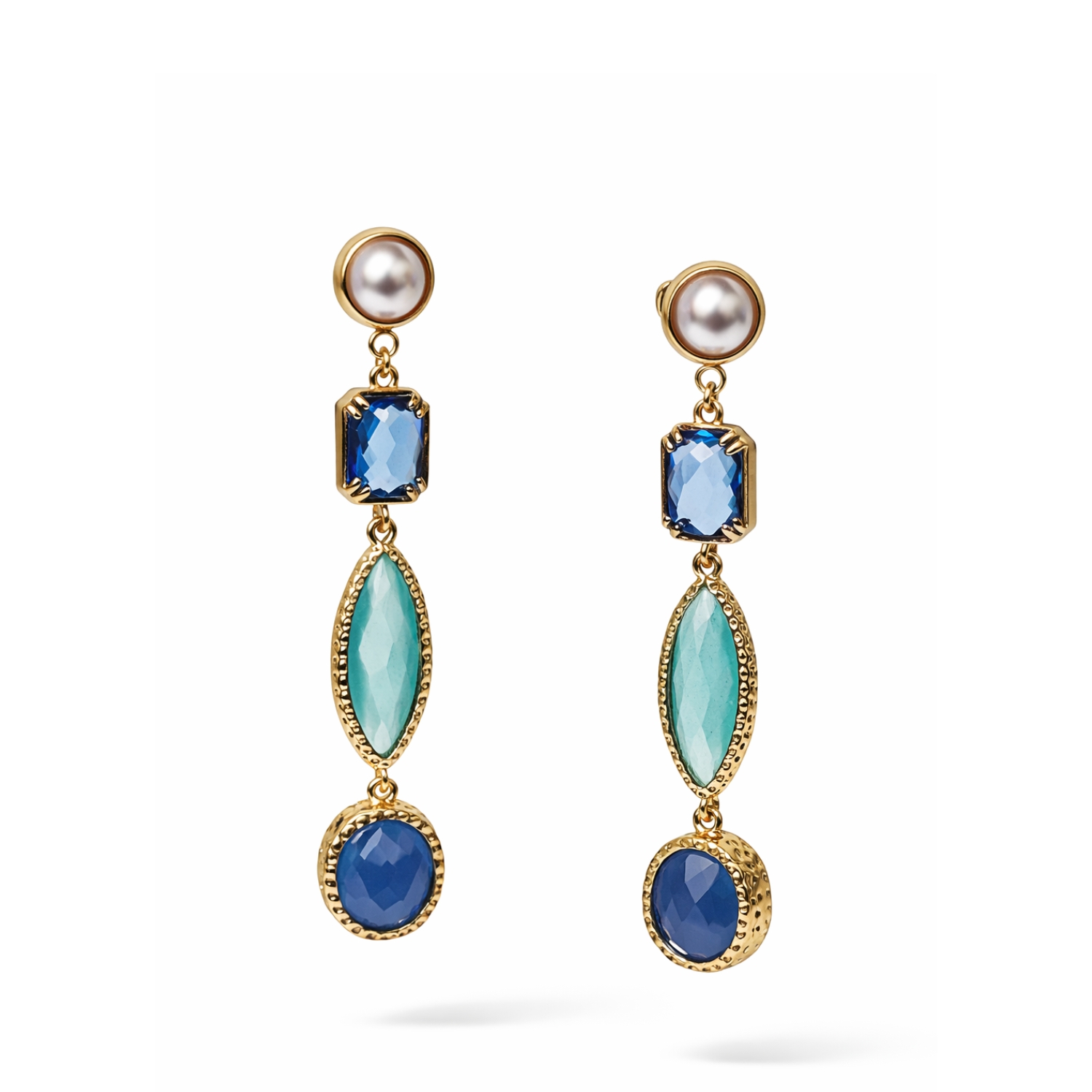 Pearl drop earrings with mint green and light blue stones in gold setting on a white background