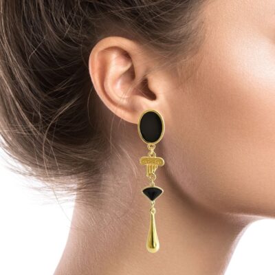 Greek-chic teardrop earrings inspired by Ancient Greece, with a gold Ionic column, teardrop, and a black crystal triangle. Dangling from a black enamel oval stud, this piece is the perfect combination of sophistication and simplicity. They are both stylish and simple, making them appropriate for any occasion. Available in blue & red
