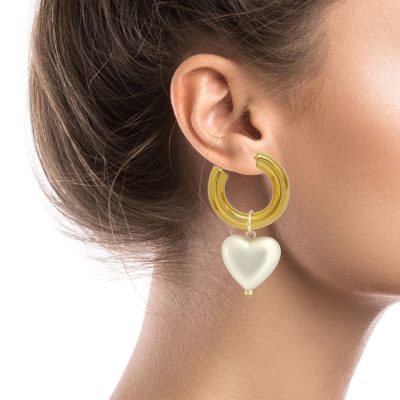 Crafted with gold-plated stainless-steel hoops, these elegant pearl earrings are a charming nod to the classics. Each hoop features a dangling pearl heart pendant, which can be removed to wear the hoops alone or worn with just one heart for a mismatched pair, giving you three pairs of earrings with one purchase. The hoops are designed with comfort and security in mind, featuring a latch closure. Elevate your look with these sophisticated earrings.