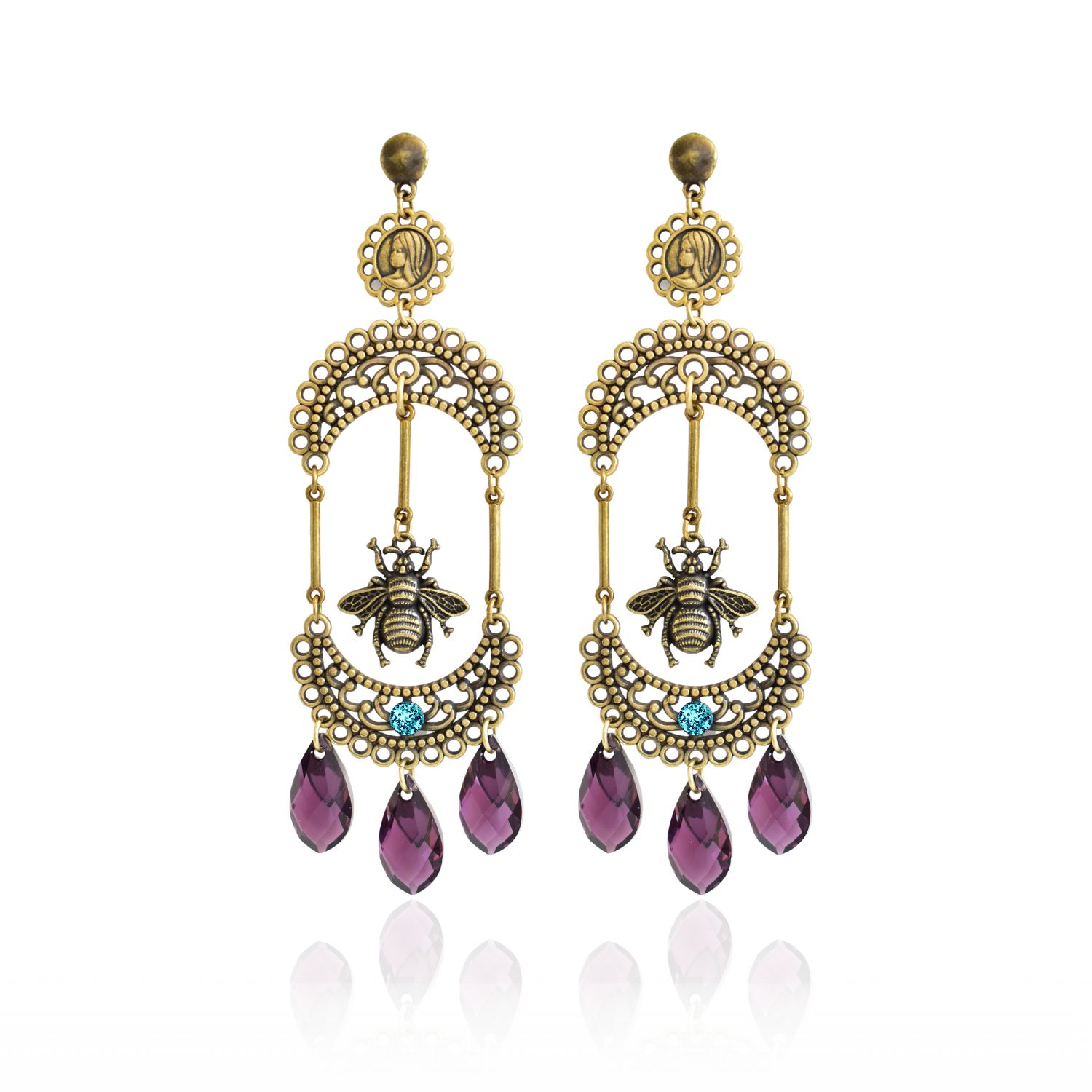 These earrings are made from Swarovski teardrops and have a handcrafted filigree design. The finish is antique bronze and adds elegance to formal outfits. They are lightweight and make a statement with their significant design. The teardrop-shaped Swarovski crystals add a touch of glamour and sparkle to these earrings, making them a must-have accessory for any occasion. Whether you're dressing up for a night out or keeping it casual for a day of shopping, these earrings will elevate your look with their sophisticated style. The crescent filigree design is handcrafted with great care and attention to detail, ensuring that these earrings are not only beautiful, but also durable and long-lasting. The Madonna medallion and fly charm add a unique touch, making these earrings a true one-of-a-kind piece. The super lightweight design makes these earrings comfortable to wear for extended periods of time, so you can rock your look with confidence all day long. Whether you're heading to a formal event or just running errands, these earrings are sure to make you feel fabulous. So if you're looking for a stylish and sophisticated accessory that will turn heads, these handcrafted crescent filigree Swarovski teardrop earrings are the perfect choice. So dare to dangle and make a statement with your style today!