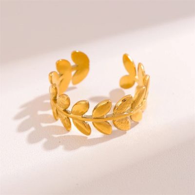 A 24K gold-plated adjustable ring featuring a delicate laurel leaf design. The band is crafted to resemble a wreath of small, intricately detailed leaves that wrap around the finger. The ring has an open-ended structure, allowing for a comfortable and flexible fit. The polished gold finish highlights the texture of the leaves, giving it a timeless and elegant appearance, inspired by ancient Greek victory wreaths.