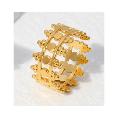 This ring features a luxurious gold-plated finish with intricate cut-out details, creating a bold yet elegant statement. The design is highlighted by delicate round motifs and small bead accents that add texture and dimension. Its open, adjustable band ensures a comfortable fit, making it versatile for various finger sizes. Perfect for adding a touch of sophistication to everyday outfits or elevating special occasion looks, this ring embodies timeless style with a contemporary edge.
