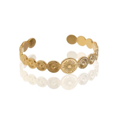 A gold-plated cuff bracelet featuring a row of circular medallions, each adorned with intricate sunburst patterns, symbolizing radiance and warmth. The bracelet has an open design for adjustability and a polished finish for a luxurious look.