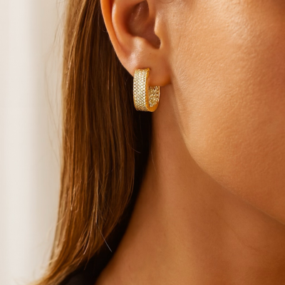 Gold rectangular pavé huggie earrings with micro-crystal detailing on a white background.