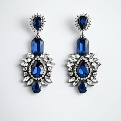 Selene statement earrings with sapphire blue crystals on a white background Selene crystal drop earrings, front view. Selene statement earrings symmetrical product photo.