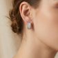 Silver pavé rectangular huggie earrings with sparkling clear stones and click closure, shown in a three-quarter view on a white background.