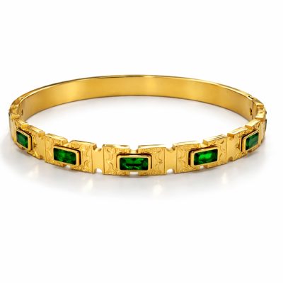 Gold bangle bracelet with rectangular green stones and engraved links on a white background