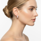 Rose gold pavé huggie earrings with rectangular silhouette and clear crystal stones, photographed on a model